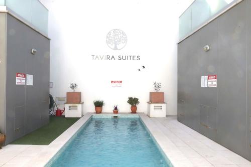 a swimming pool in a room with a swimming pool at Luxury Townhouse, in Tavira Centre with shared pool in Tavira