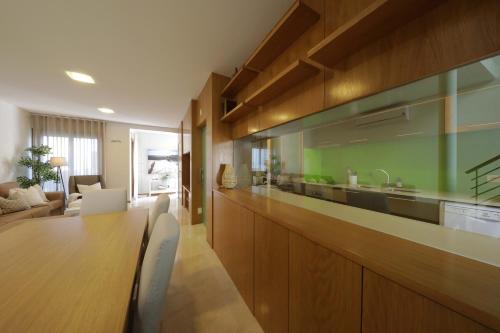 a kitchen with a long wooden counter with a table at Luxury Townhouse, in Tavira Centre with shared pool in Tavira