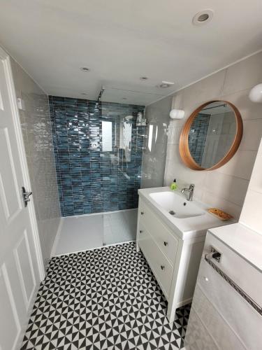 a bathroom with a white sink and a shower at The Old Wire Factory in Bristol