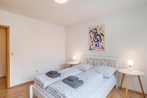 a bedroom with a bed with two towels on it at Aposto Apartments 2 in Oberderdingen
