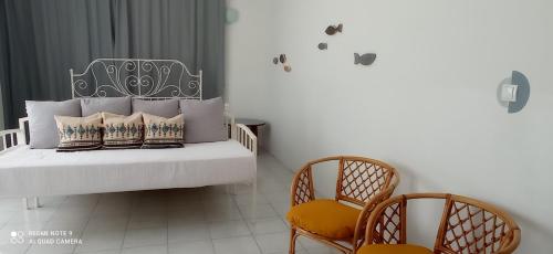 a bedroom with a bed with two chairs at Mala Marta, 60qm room, near beach in Kaštela