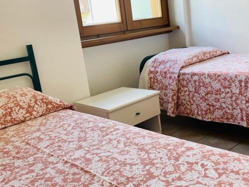Un ou plusieurs lits dans un hébergement de l'établissement Foresteria Miramonti affittacamere