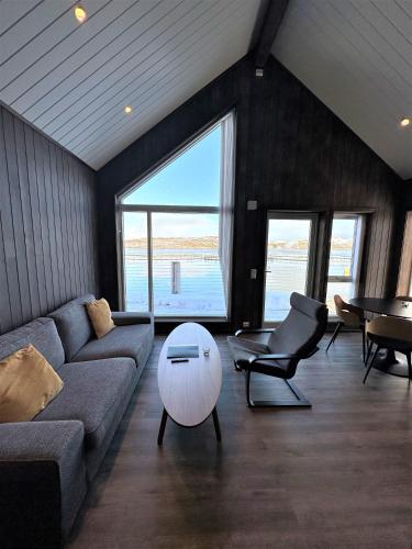 a living room with a couch and a table at Norsk Havbrukssenter - Rorbuer in Brønnøysund