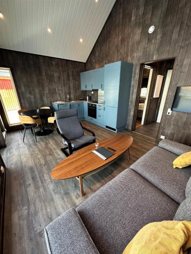 a living room with a couch and a table at Norsk Havbrukssenter - Rorbuer in Brønnøysund