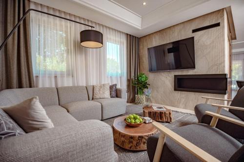 a living room with a couch and a tv at Luxury Villa Lipa Kate in Garica