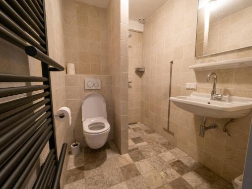 a bathroom with a toilet and a sink at Op adem komen op de mooiste plek in het heuvelland-De Boswachter in Vijlen