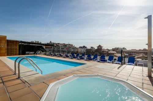 a swimming pool on the roof of a building at Sunotel Aston in Barcelona