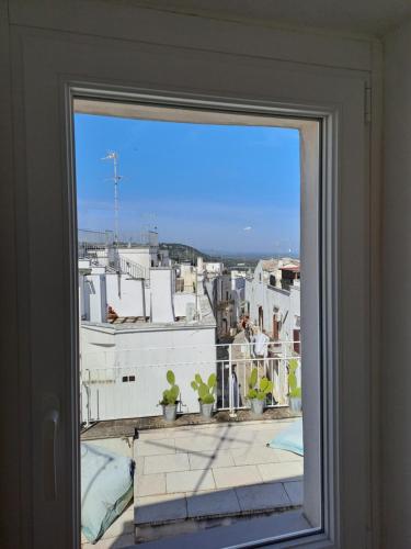 a view of a city from a window at Palazzo AD 1892 - SUITES & SPA in Ostuni