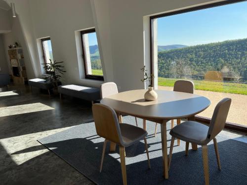 a dining room with a table and chairs and a large window at Casa Galego in Fonfría