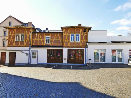 a large building on a cobblestone street at Musashi Apartment 2 in Weimar