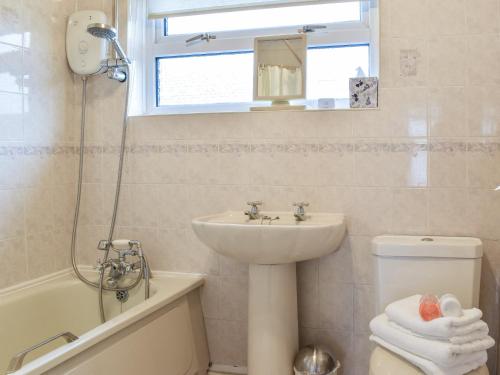 a bathroom with a sink and a toilet and a shower at Maureg Formby in Formby