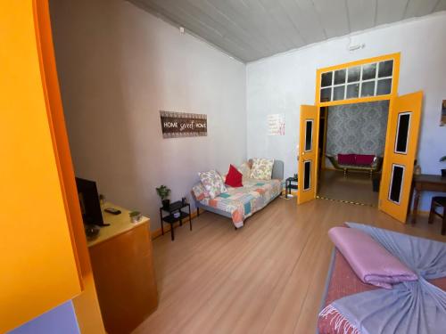 a living room with a couch and a tv at Faroway Hostel in Faro