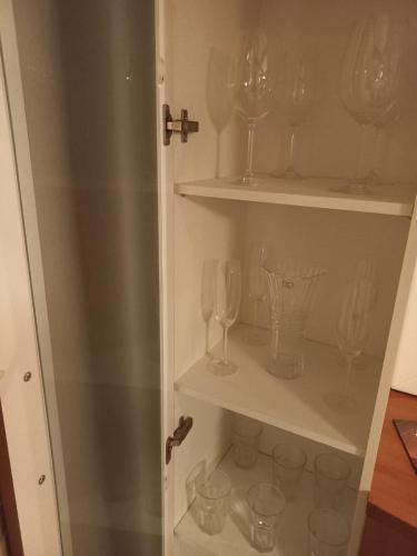 a cupboard with wine glasses in it at Privilege Apart hotel Mountain Village in Canela