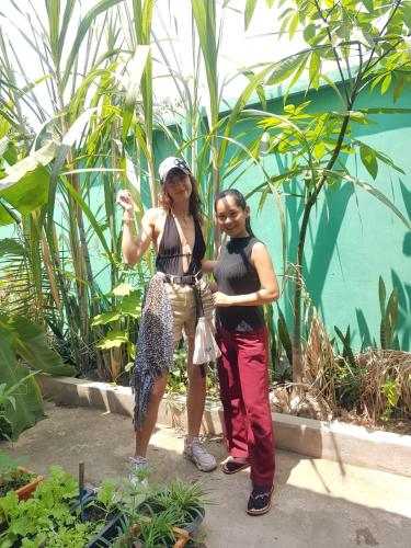 two women standing next to each other in a garden at Bloom Garden Bed & Breakfast in Siem Reap
