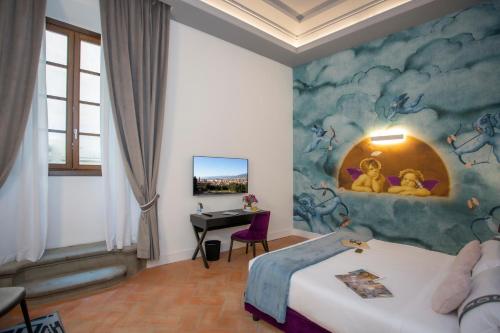 a bedroom with a bed and a desk in it at Casual Rinascimento Firenze in Florence