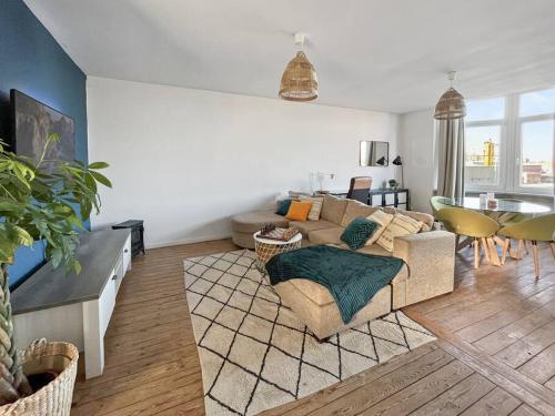 a living room with a couch and a table at Cozy Antwerp - Zurenborg Skyline in Antwerp