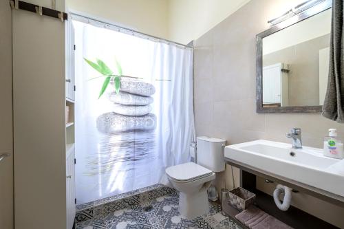 a bathroom with a toilet and a sink and a shower at Casa Vecchia 1930’s Central Masterpiece in Kos Town