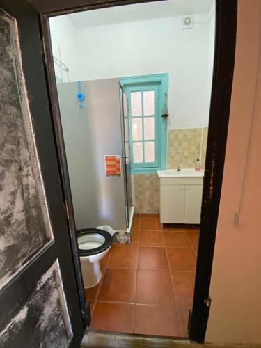 a bathroom with a toilet and a sink at Faroway Hostel in Faro