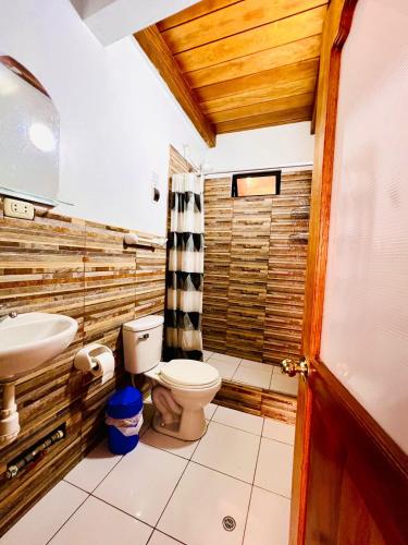 a bathroom with a toilet and a sink at Tayta Abraham Hospedaje in Lamas