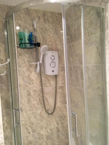 a shower in a bathroom with a glass shower stall at Private One Bedroom Apartment in Slades Green