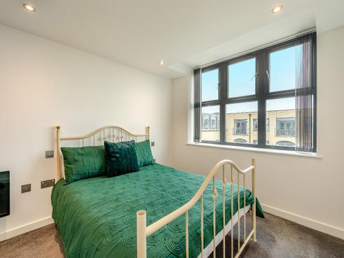 a bedroom with a bed and a window at Queens Bridge Apartment in Ramsgate
