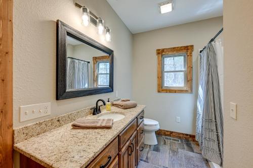 een badkamer met een wastafel, een toilet en een spiegel bij Smoky Mountain Cabin Rental Game Room, Fire Pit! in Andrews