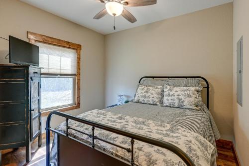 een slaapkamer met een bed, een tv en een raam bij Smoky Mountain Cabin Rental Game Room, Fire Pit! in Andrews