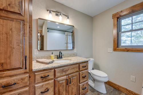 a bathroom with a sink and a toilet and a mirror at Smoky Mountain Cabin Rental Game Room, Fire Pit! in Andrews