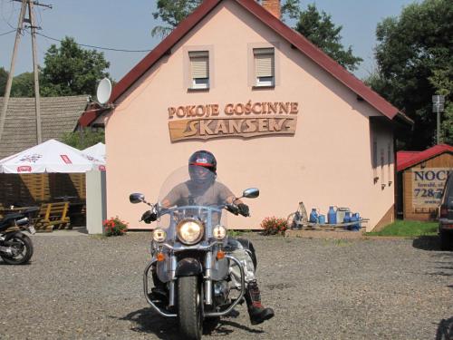 a man riding a motorcycle in front of a building at Gościniec Grek Zorba - pokoje i domki 4 osobowe - 16km od Zator Energylandia in Inwałd