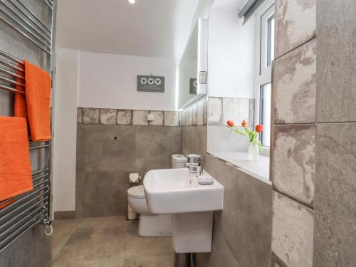 a bathroom with a sink and a toilet at Bess Cottage in Hebden Bridge