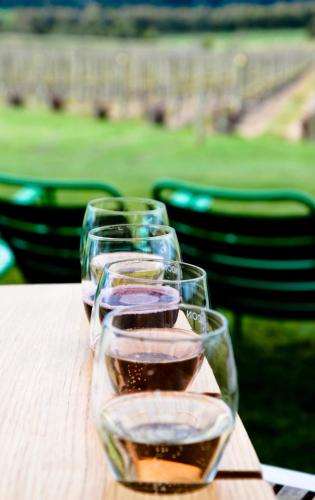a row of wine glasses sitting on a table at Leafield Cottages in Dixons Creek