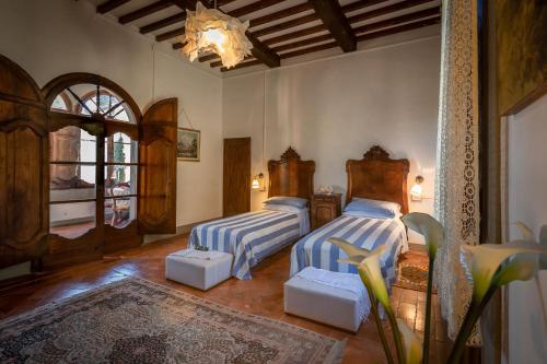Katil atau katil-katil dalam bilik di Alloggi in Villa storica