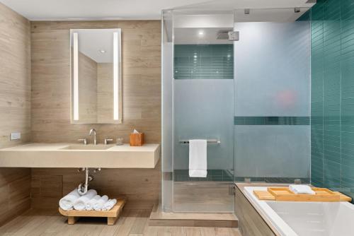 a bathroom with a sink and a shower at EAST Miami Residences in Miami