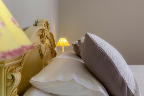 a bedroom with a bed with a lamp on it at Le Boulevard in Corfu Town