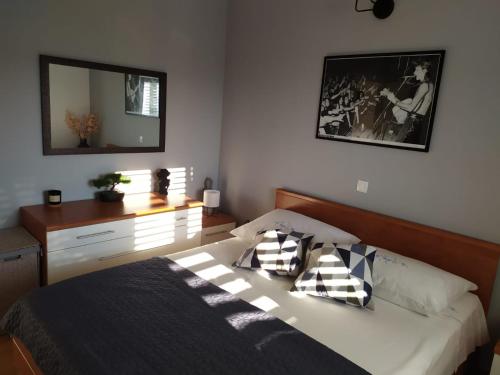 a bedroom with a bed with two pillows and a mirror at The View in Labin