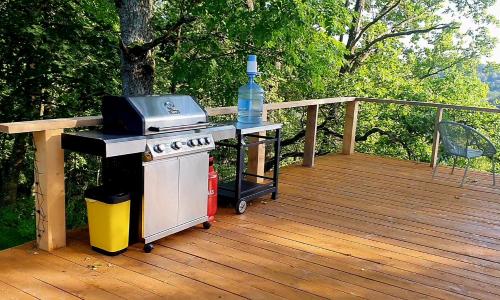 a stove with a bottle of water on a deck at Glamping Žvaigždžių slėnyje 