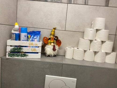 a shelf with rolls of toilet paper and a stuffed animal at Mallo's Lodge avec Parking GRATUIT et 2 balcons in Colmar