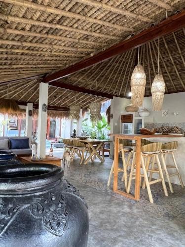 a living room with a table and some chairs at Villa Anjing in Nusa Dua