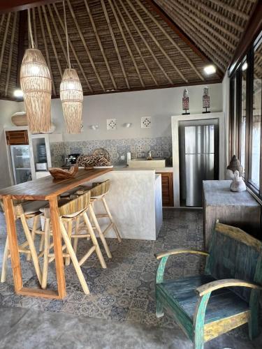 a living room with a wooden table and chairs at Villa Anjing in Nusa Dua
