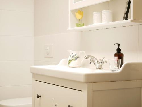 a bathroom with a white sink and a toilet at Wolke 7 in Görwihl