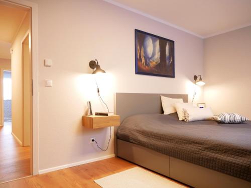 a bedroom with a bed with two lamps on it at Wolke 7 in Görwihl