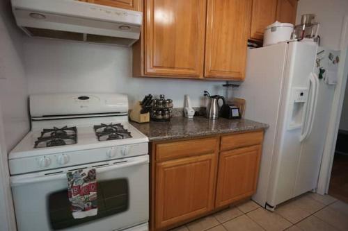 a kitchen with a white stove and a refrigerator at North Berkeley Home in Berkeley