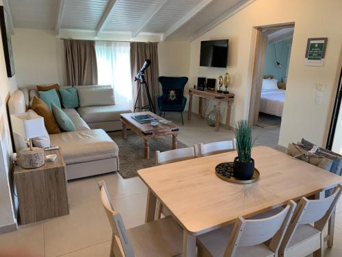 a living room with a table and a couch at Sirios in Acharavi