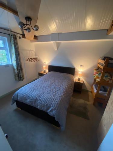 a bedroom with a king sized bed in a room at The Shack plus Camping in Llandinam