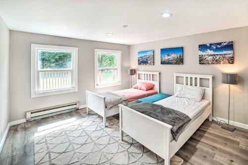 a bedroom with two beds and two windows at Modern Gold Bar Vacation Rental with Mountain View in Gold Bar