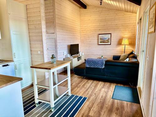 a living room with a couch and a table at Klettur in Borgarnes