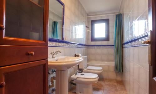 a bathroom with a white toilet and a sink at Cala mezquida - 42214 Mallorca in Capdepera
