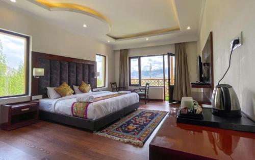 a bedroom with a large bed and a large window at Hotel Deskitsal in Leh