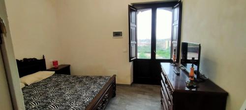 Кровать или кровати в номере Agriturismo Gli Aranci dell'Etna