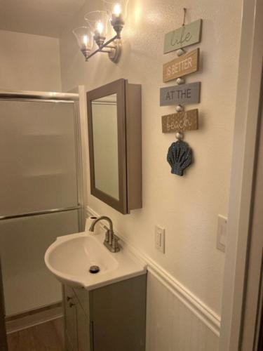 a bathroom with a sink and a mirror at Relaxing River Family Retreat in Bullhead City